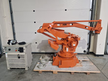 Load image into Gallery viewer, Orange ABB IRB 640 M2000 industrial robot placed on a wooden pallet, shown with its controller and TPU2 teach pendant. This 2003 model is designed for heavy material handling, machine loading, spot welding, and palletizing large parts. > for sell > offer 
